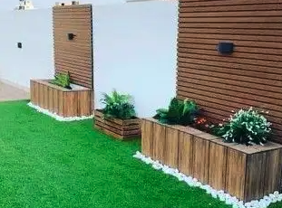 تنسيق حدائق جيزان عشب صناعي شلال وجلسات